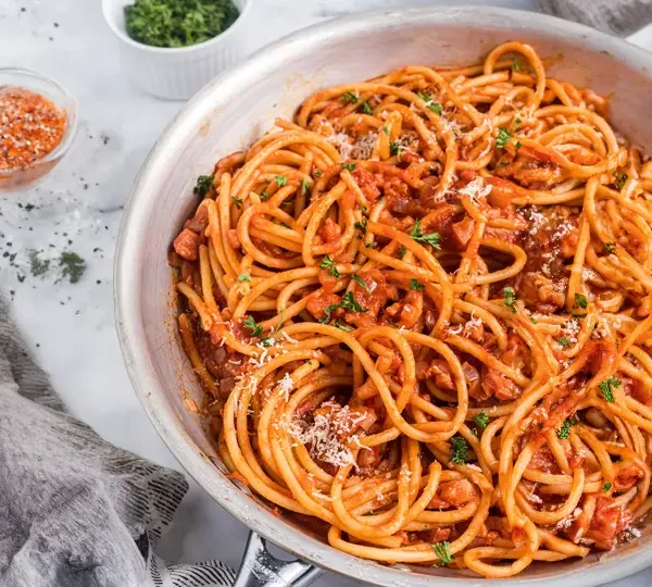 Explore the classic Bucatini all’Amatriciana recipe, a traditional Italian pasta dish with tomato, pancetta, and pecorino cheese. Try it now!