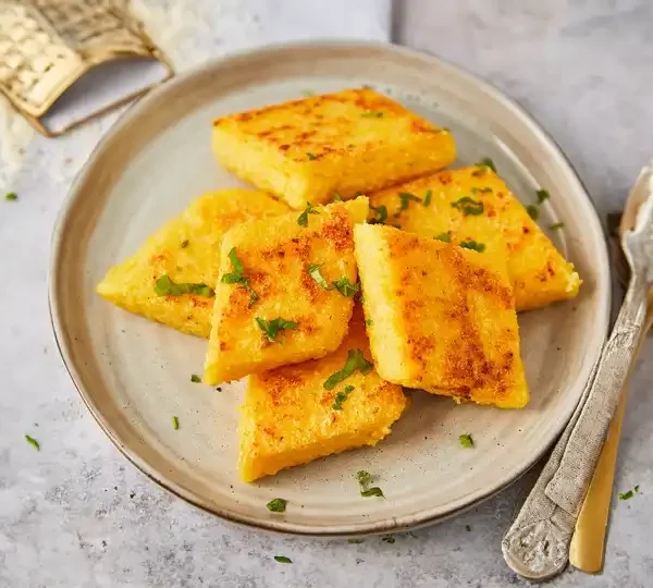 Enjoy the savory goodness of grilled Parmigiano cheese Mozzarella polenta. A perfect side dish for any meal. Try it today!