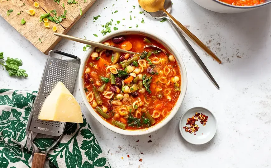 Warm up with our comforting Minestrone Soup recipe. A hearty blend of vegetables and beans in a flavorful broth, perfect for cozy evenings at home.