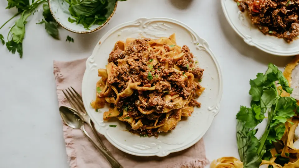 Learn how to make the authentic Tagliatelle alla Bolognese dish at home. A hearty Italian pasta recipe that's sure to impress. Try it now!